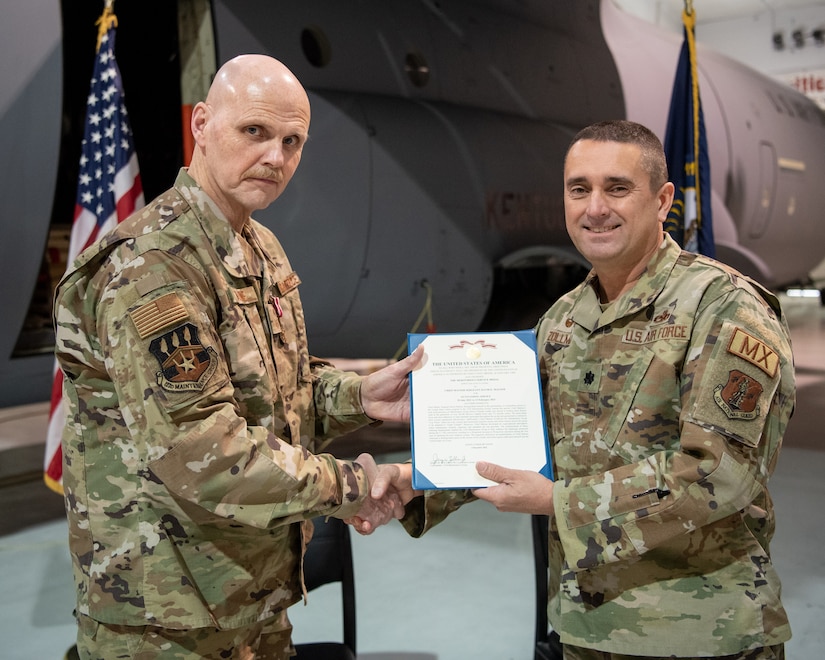 Chief Master Sgt. David Malone, left, 123rd Maintenance Group senior enlisted advisor, receives the Meritorious Service Medal from Lt. Col. Jerry Zollman, 123rd Maintenance Group commander, during Malone’s retirement ceremony at the Kentucky Air National Guard Base in Louisville, Ky., Feb. 5, 2023. Malone is retiring after more than 35 years of service to the Kentucky Air National Guard and United States Air Force. (U.S. Air National Guard photo by Tech. Sgt. Joshua Horton)