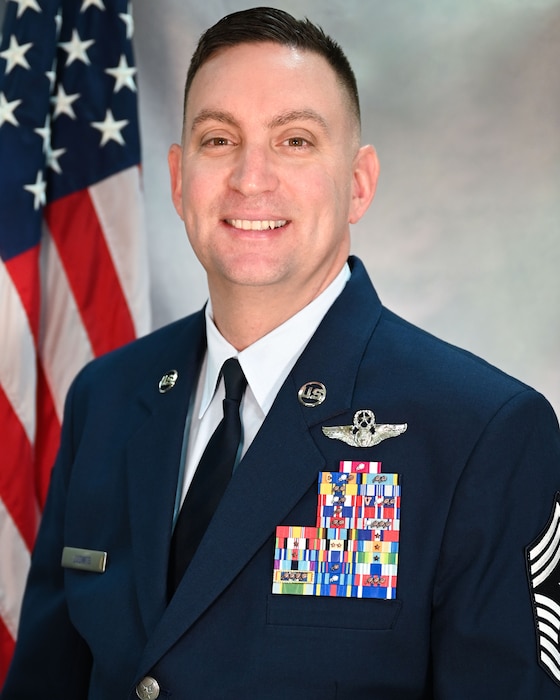 Man in Air Force uniform in front of American flag