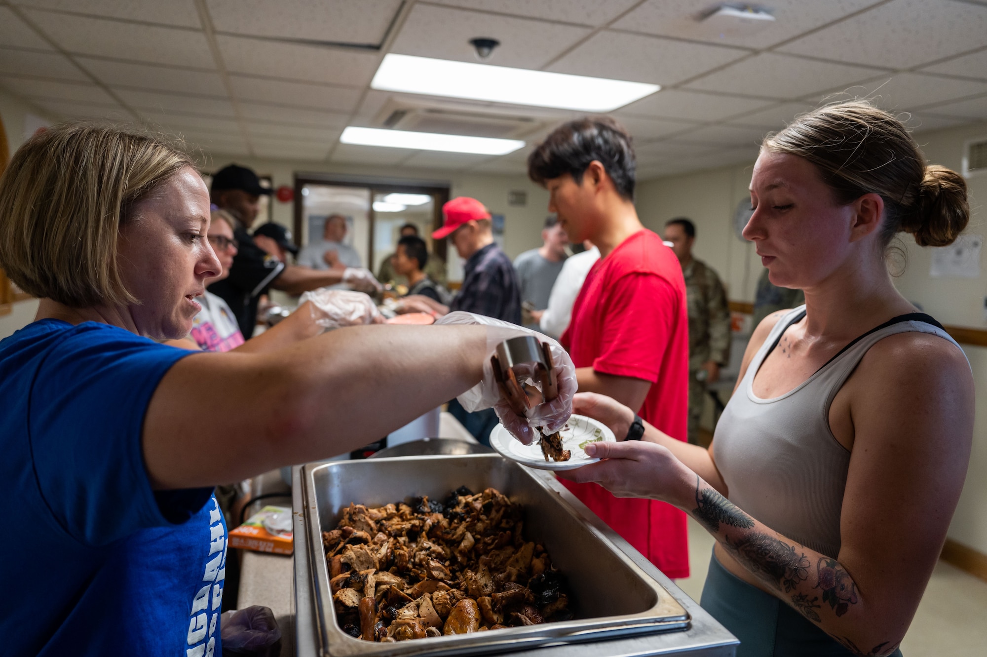 8th Operational Medical Readiness Squadron commander, serves food to 8th Fighter Wing Airmen during a Home Away From Home event at Kunsan Air Base