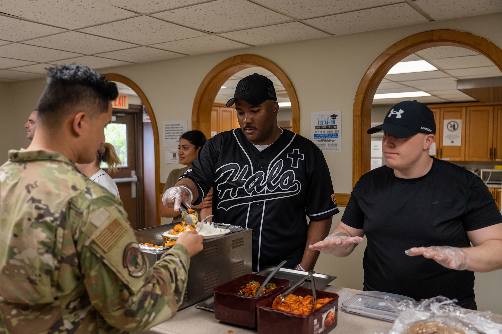 8th Fighter Wing chaplain, and Staff Sgt. Jeffrey Higgins serve food during a Home Away From Home event at Kunsan Air Base