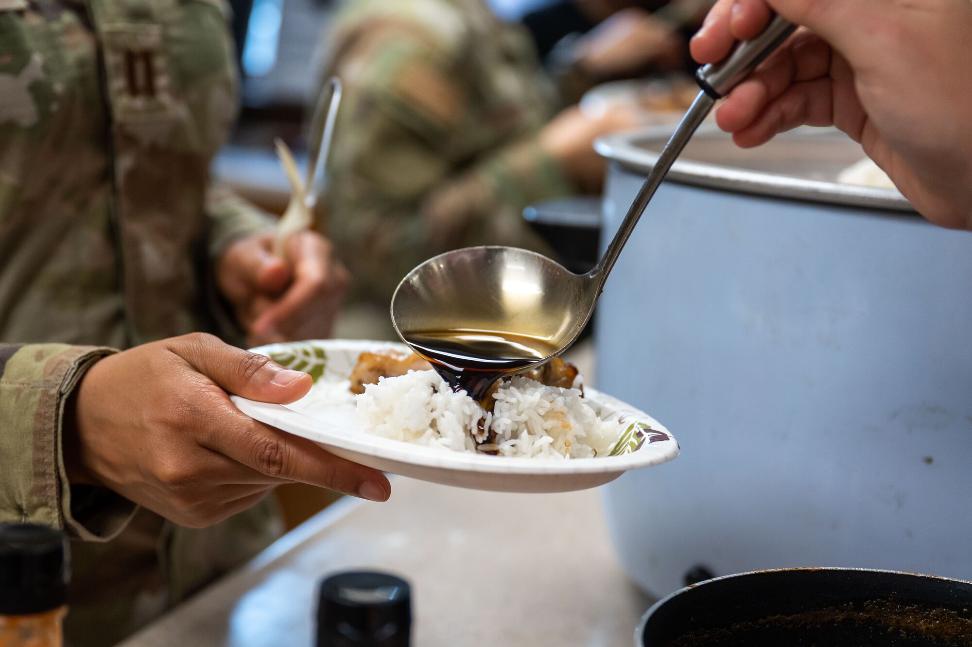 8th Operational Medical Readiness Squadron public health flight chief, serves condiments during a Home Away From Home event at Kunsan Air Base