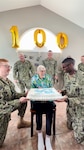 ST. LOUIS, Missouri (July 28, 2023) - World War II-Era Navy Machinist Mate 2nd Class William Hales (center) is photographed in celebration of his 100th birthday. Hales served in the United States Navy from 1942 to 1948. (U.S. Navy photo by Hospital Corpsman 2nd Class Jacob Decena)