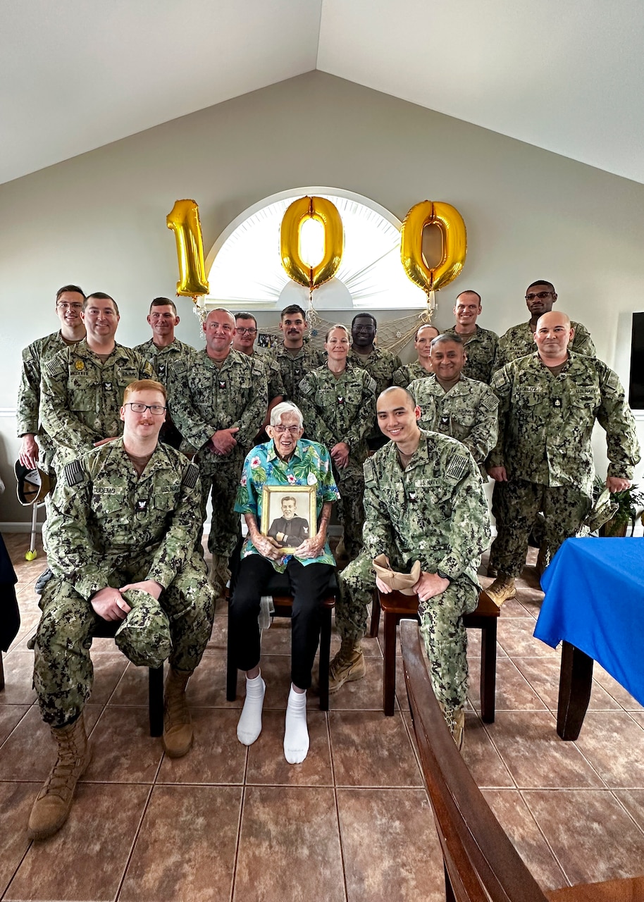 ST. LOUIS, Missouri (July 28, 2023) - World War II-Era Navy Machinist Mate 2nd Class William Hales (center) is photographed in celebration of his 100th birthday. Hales served in the United States Navy from 1942 to 1948. (U.S. Navy photo by Hospital Corpsman 2nd Class Jacob Decena)