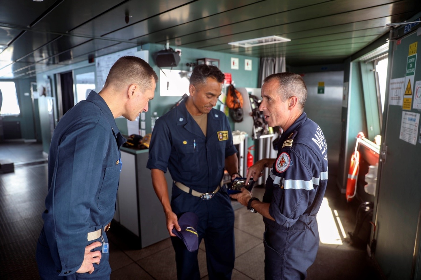 TYRRHENIAN SEA (July 20, 2023) Capt. Edward Sundberg, commodore of Destroyer Squadron (DESRON) 60 and commander of Task Force (CTF) 65, and Cmdr. Corry Lougee, commanding officer of the Arleigh Burke-class guided-missile destroyer USS Paul Ignatius (DDG 117), meet with Capt. Laurent Saunois, commanding officer of the French Navy frigate FS Languedoc (D 653), July 20, 2023. Ignatius is on a scheduled deployment in the U.S. Naval Forces Europe area of operations, employed by the U.S. Sixth Fleet to defend U.S., allied and partner interests. (U.S. Navy photo by Mass Communication Specialist 1st Class Zac Shea)