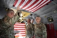 U.S. Army Reserve Lt. Col. Enriquez Baez, an engineer officer with the 2nd Battalion 323rd Regiment  raises his right hand and recites the Oath of the Commissioned Officer  with Brig. Gen. Christopher Cook during his promotion ceremony on a CH-47 Chinook at Joint Base Mcguire-Dix-Lakehurst on July 25, 2023. The Chinook belongs to the 244th Expeditionary Combat Aviation Brigade and was utilized for the promotion and a reenlistment Ceremony. (U.S. Army Reserve photo by Pfc. Aiden Griffitts)