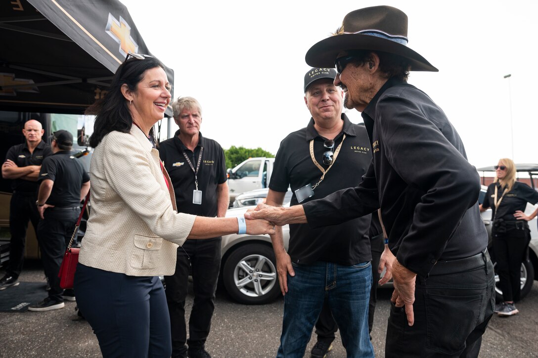 Kristyn Jones, assistant secretary of the Air Force for Financial Management and Comptroller, performing the duties of the under secretary of the Air Force, meets Richard Petty, NASCAR hall of famer and Legacy Motor Club team ambassador at Pocono Raceway, Pa., July 23, 2023. Jones visited the raceway to participate in the Air Force recruiting mission at the NASCAR Cup Series race as part of a longstanding partnership with Legacy Motor Club. (U.S. Air Force photo by Staff Sgt. Jacob B. Derry)