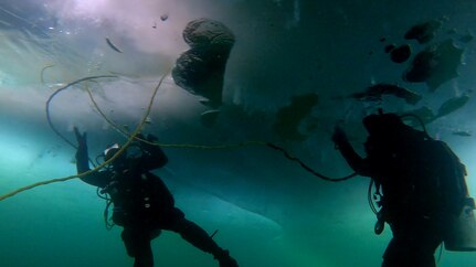 SHERIDAN LAKE, British Columbia (March 14, 2023) Divers conduct an emergency search procedures drill under the ice of Sheridan Lake, British Columbia, while participating in an Ice Diving Exercise (ICEDIVEX) involving Mobile Diving and Salvage Unit (MDSU) 1 and the Canadian Armed Forces’ Fleet Diving Unit Pacific, March 14, 2023. The ICEDIVEX enhanced interoperability between U.S. and Canadian diving units by accomplishing joint technical diving and unit-level training evolutions. MDSU-1 is a component of Explosive Ordnance Disposal Group (EODGRU) 1 that provides combatant commanders the expeditionary capability to clear ports, piers and waterways; assist vessels in distress; and conduct salvage of ships, aircraft and other objects from the water. (U.S. Navy courtesy photo) 230314-N-N2422-0003