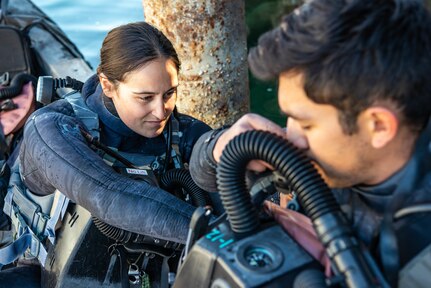 NORTHERN CALIFORNIA - U.S. Navy Divers assigned to Naval Special Warfare Logistics Support Unit 1 (LOGSU-1) assist each other with their MK-25 underwater breathing apparatus before a high-altitude dive. The exercise organized by LOGSU-1 is designed to qualify and maintain Naval Special Warfare personnel's altitude diving proficiency and provide opportunities for instructor qualification. (U.S. Navy photo by Mass Communication Specialist 2nd Class Alex Perlman)