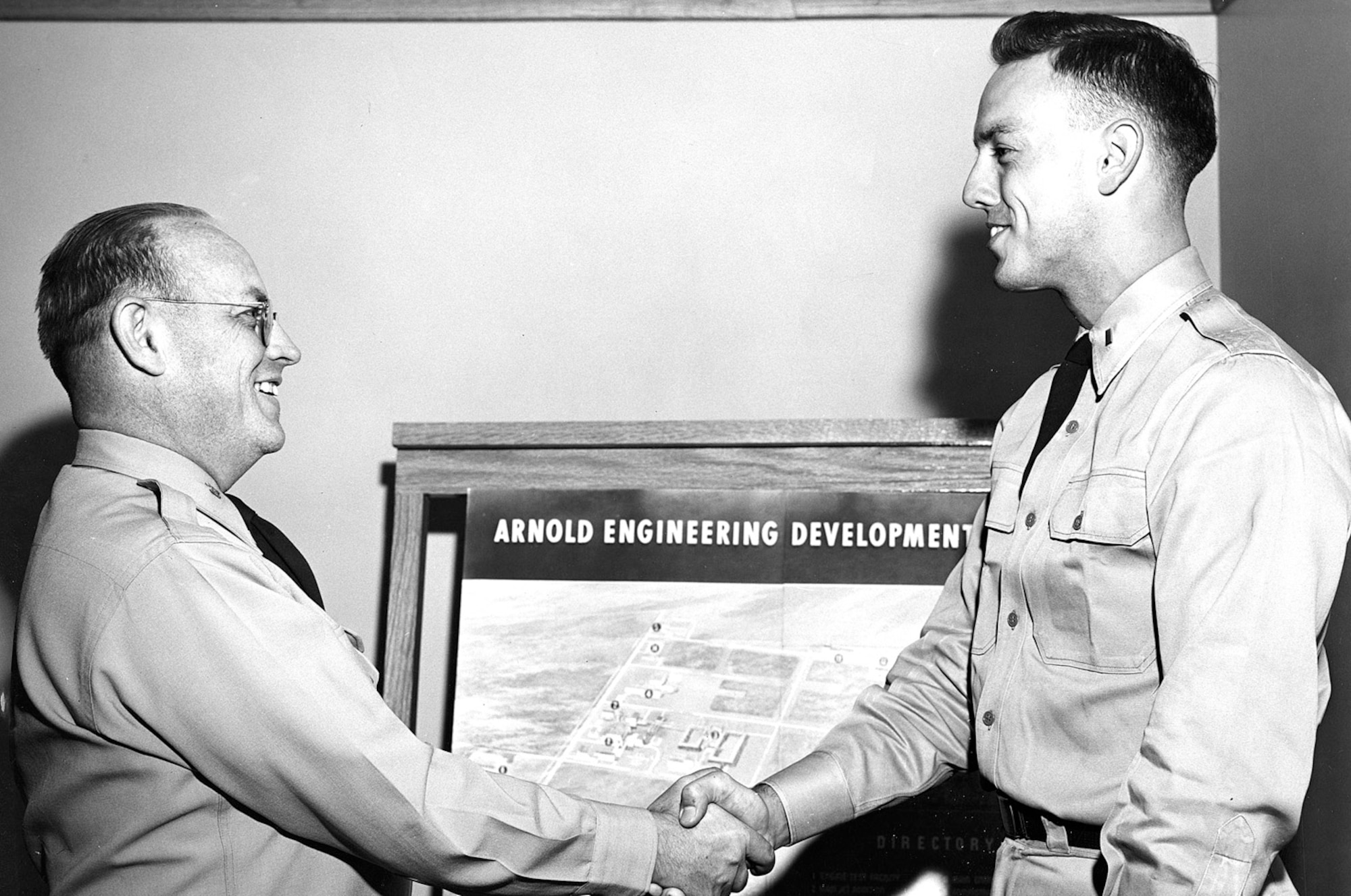 Then-Arnold Engineering Development Center Vice Commander Col. William L. McCulla, left, shakes the hand of Lt. James Mitchell after pinning the junior officer with his 1st lieutenant bars in 1955. (U.S. Air Force photo)