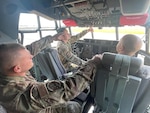 U.S. Air Force Staff Sgt. Tristan Grigsby, center, a C-130H Hercules maintainer assigned to the Advanced Airlift Tactics Training Center, Missouri Air National Guard, is trained on C-130J systems by Airmen with the 123rd Airlift Wing, Kentucky Air National Guard, at Louisville Air National Guard Base, Kentucky, May 3, 2023. During the two-week training, Grigsby and Senior Master Sgt. Ryan Breyfogle, aircraft maintenance superintendent with the AATTC, learned J-model fundamentals such as power on checklists, fueling operations, aircraft towing, operating radios, and general troubleshooting.