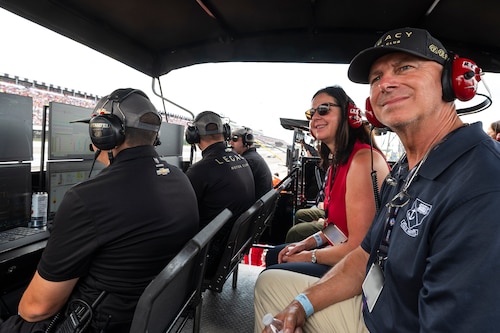 Kristyn Jones, assistant secretary of the Air Force for Financial Management and Comptroller, performing the duties of the under secretary of the Air Force, and her husband Skip, watch the NASCAR race at Pocono Raceway, Pa., July 23, 2023. Jones visited the raceway to participate in the Air Force recruiting mission at the NASCAR Cup Series race as part of a longstanding partnership with Legacy Motor Club. (U.S. Air Force photo by Staff Sgt. Jacob B. Derry)