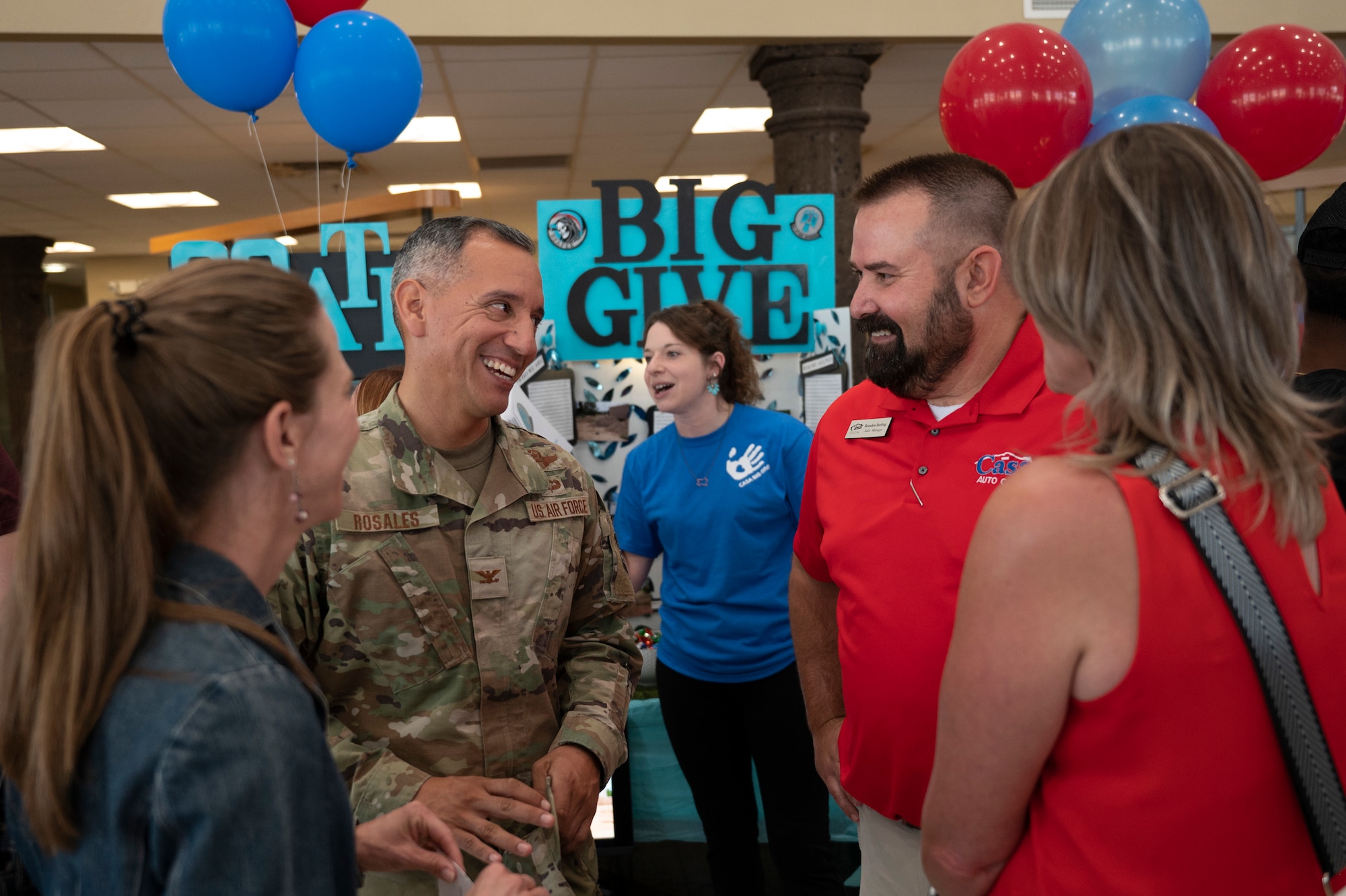 U.S. Air Force Col. Alfred Rosales, 49th Wing deputy commander, center, and members from Casa Auto Group discuss community projects during the closing ceremony in Alamogordo, New Mexico, July 28, 2023. The 13th annual Big Give event was composed of active duty Airmen, civilians and retirees working together to complete projects that benefit the local community. (U.S. Air Force photo by Airman 1st Class Michelle Ferrari)