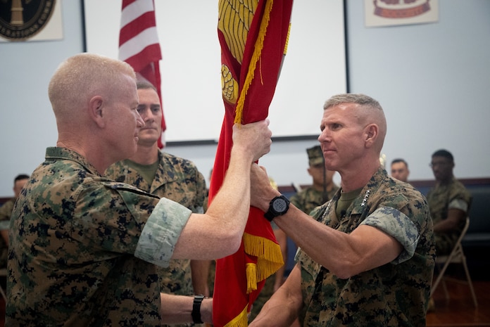 U.S. Marine Corps Gen. Eric Smith, the Assistant Commandant of the Marine Corps, delivers the unit colors to Maj. Gen. Paul J. Rock Jr., outgoing commander, during the U.S. Marine Corps Forces, Central Command, change of command ceremony at MacDill Air force Base, Florida, August 1, 2023. USMARCENT is designated as the Marine Corps service component for U.S. Central Command and is responsible for all Marine Corps forces in the CENTCOM area of responsibility.