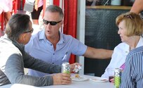 U.S. Air Force Maj. Gen. Rich Neely speaks with Linda and Army Col. (ret.) Ralph Grieco, the parents of fallen Illinois Army National Guard Staff Sgt. Kevin Grieco, during the July 29 Chicago Fire Boat Architectural Tour on Lake Michigan and the Chicago River.