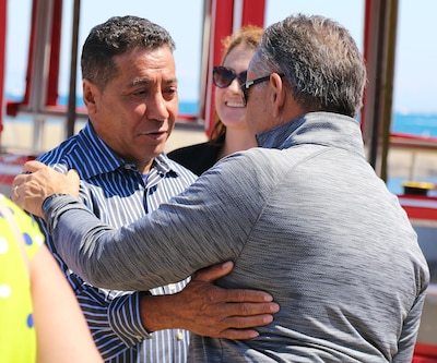 Gold Star Father Tony Vazquez (left) hugs fellow Gold Star Father Ralph Grieco after the Chicago Fire Boat Architectural Tour on Lake Michigan and the Chicago River.