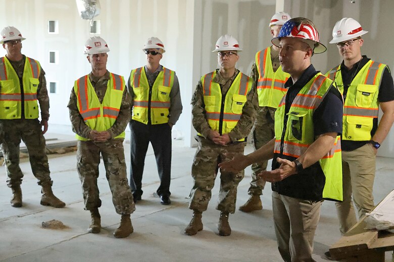 A construction contractor leads a tour of the new U.S. Army Corps of Engineers, Huntsville Engineering and Support Center building under construction at Redstone Arsenal, Huntsville, Alabama, July 27, 2023. The new building is utilizing the Enhanced Use Lease Program, an innovative way for USACE leaders to complete projects. (U.S. Army photo by Chuck Walker)
