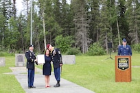 Command Sgt. Maj. Michael Grunst hugs his wife, Charity, as she is presented with an award from Maj. Patrick Gargan for her strength and contributions supporting her husband throughout his career during Grunst’s retirement ceremony July 21, 2023, at Camp Carroll on Joint Base Elmendorf-Richardson.