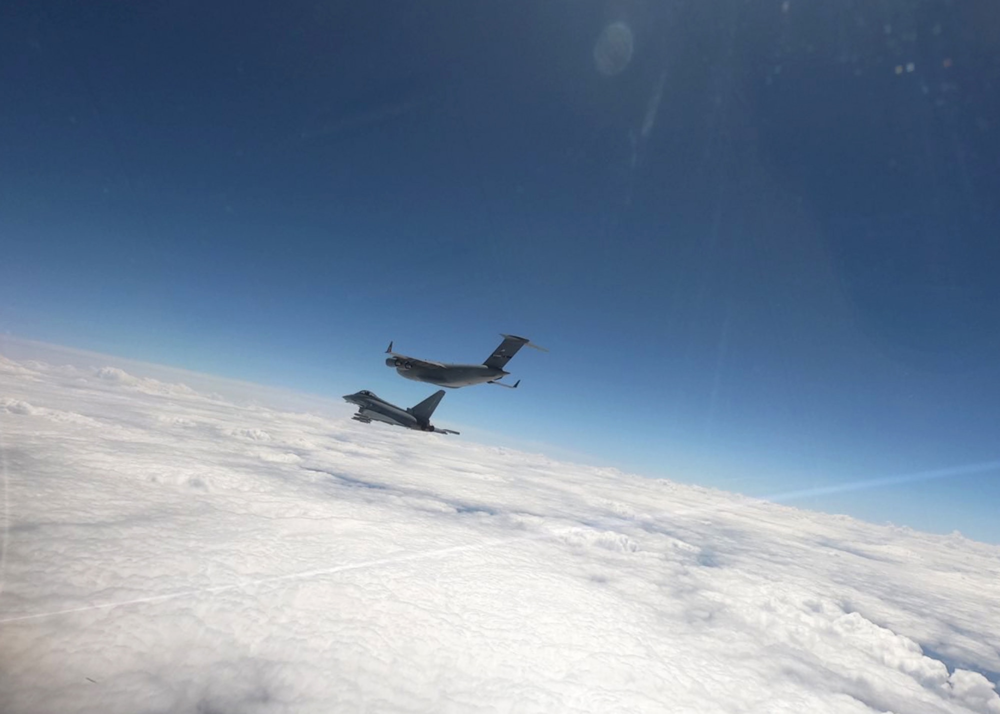 A U.S. Air Force C-17 Globemaster III aircraft assigned to the 105th Airlift Wing, New York National Guard, is intercepted by an Austrian Eurofighter, assigned to the Überwachungsgeschwader, during exercise Air Defender 2023 at Zeltweg Air Base, Austria, June 15, 2023.