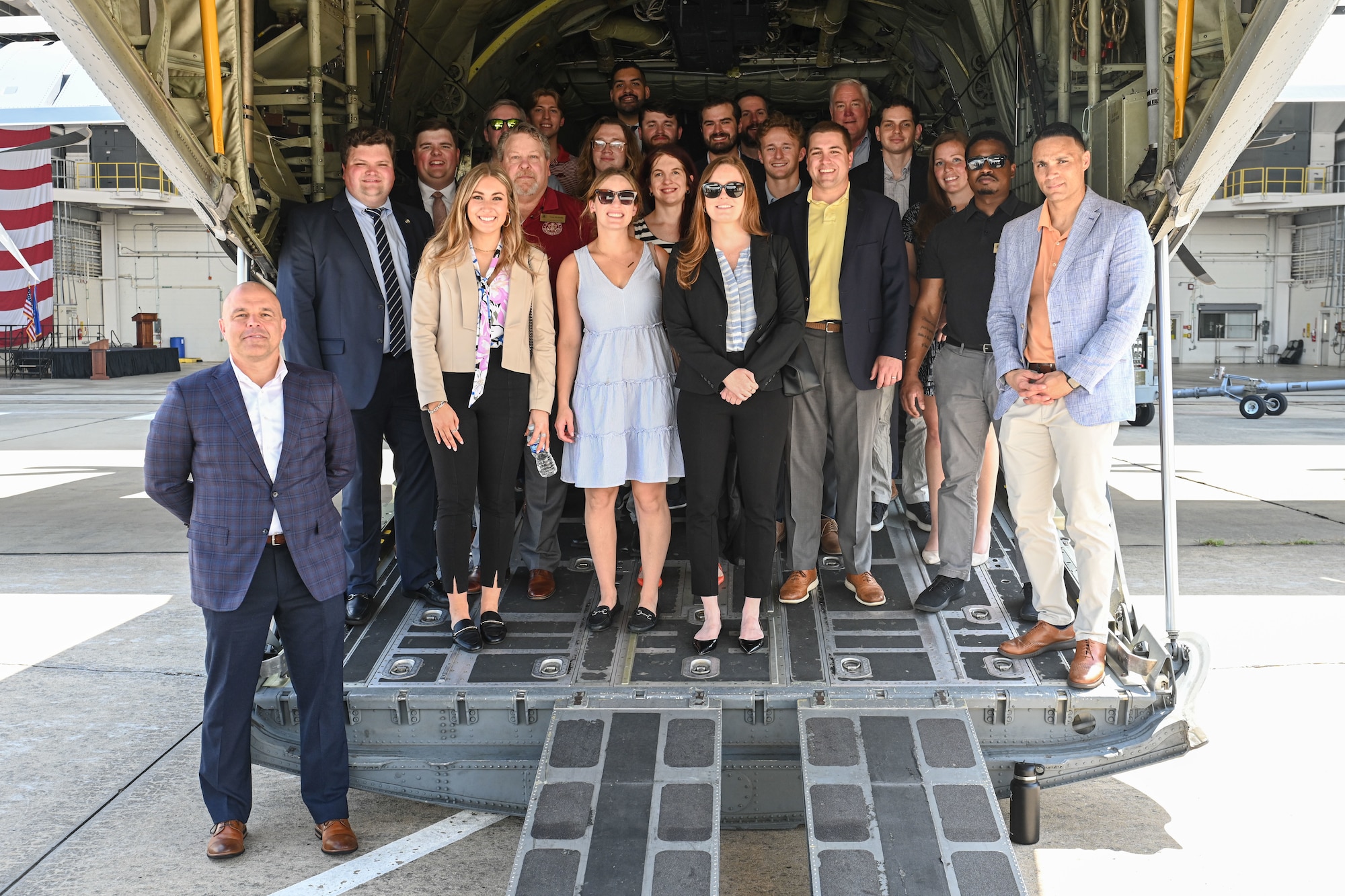 People pose in a C-130.