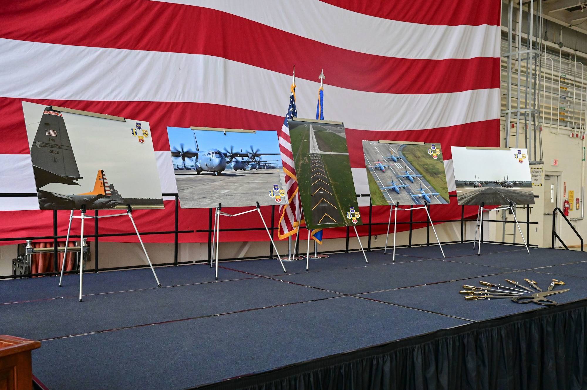 Runway photos are displayed on a stage.