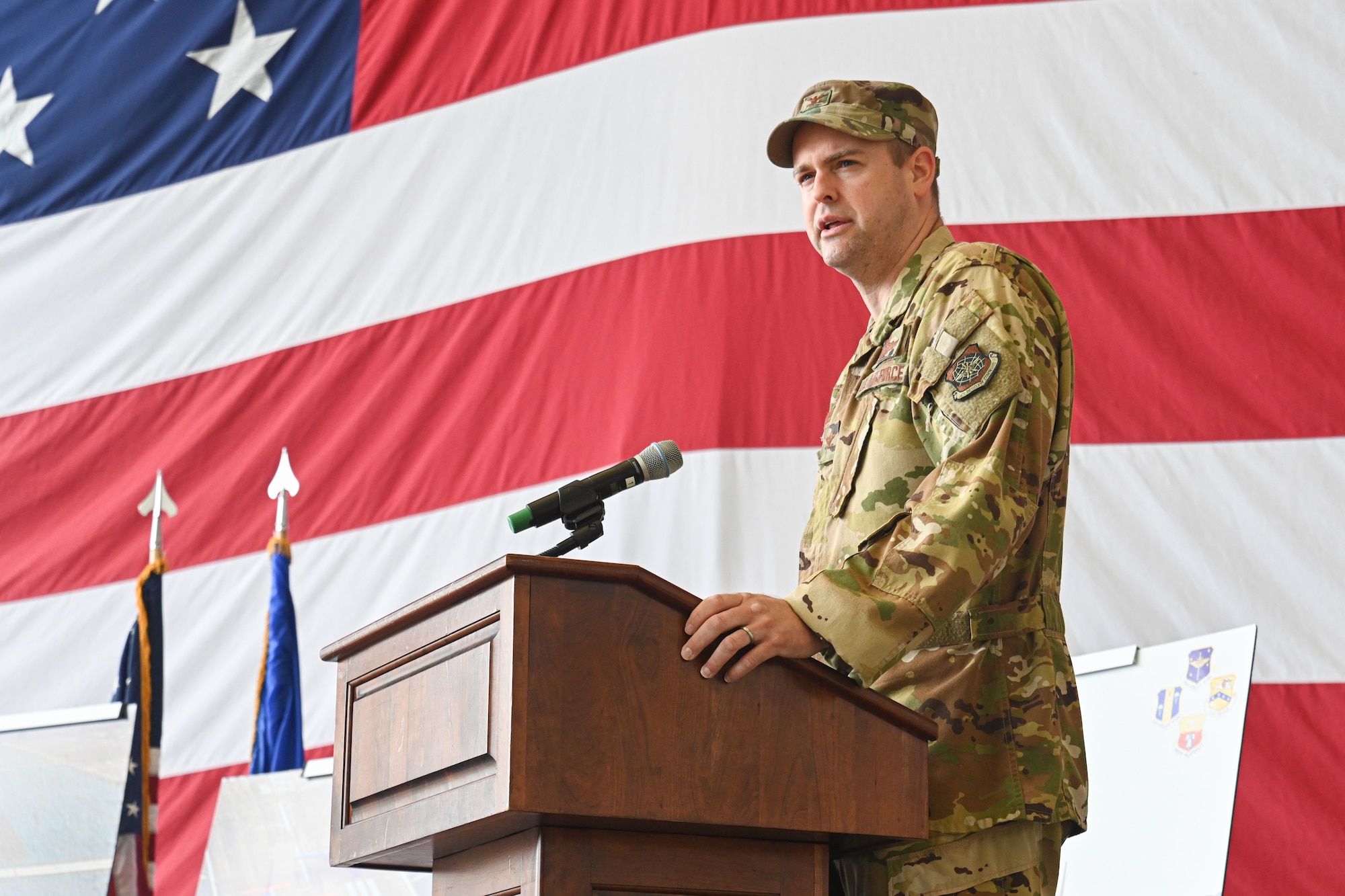 Col. Davies speaks at a podium.