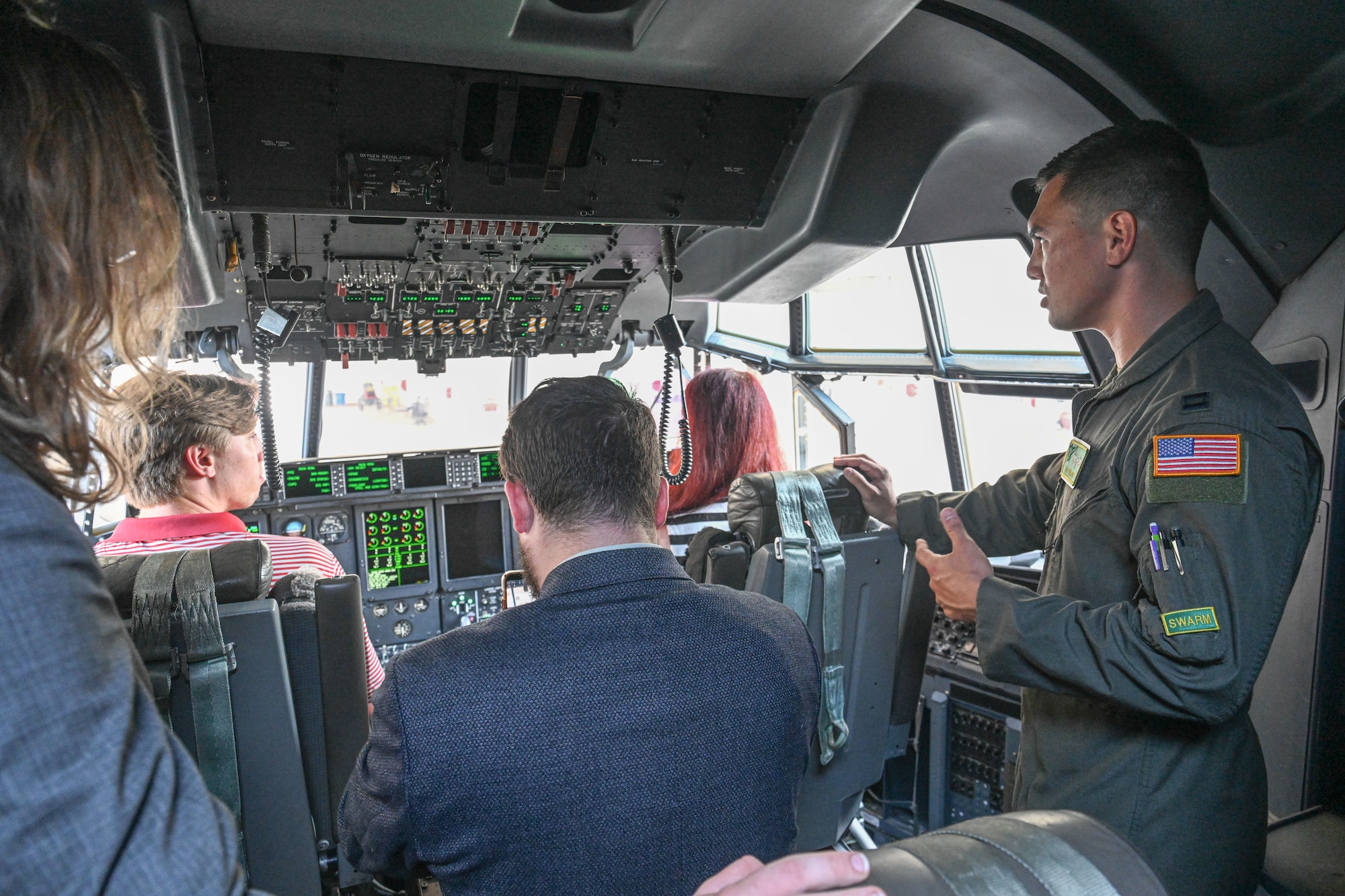 People tour the cockpit of an aircraft.