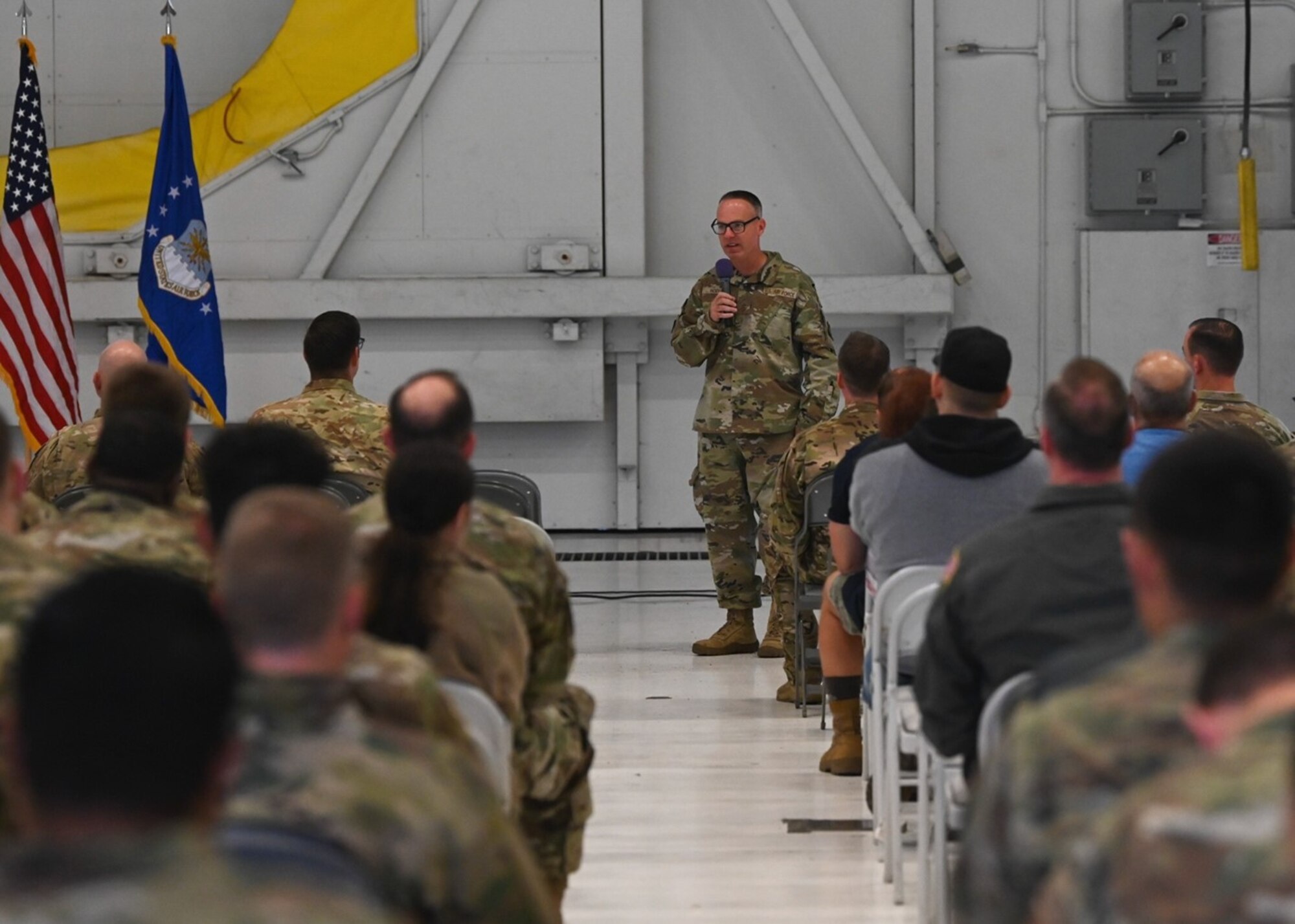 U.S. Air Force Chief Master Sgt. Timothey Hodgin, 62d Airlift Wing command chief, speaks to 62d AW Airmen during an all-call at Joint Base Lewis-McChord, Washington, July 31, 2023. Hodgin emphasized the importance of Team McChord Airmen understanding their role in the mission and their importance and lethality as Mobility Warfighters. (U.S. Air Force photo by Senior Airman Callie Norton)