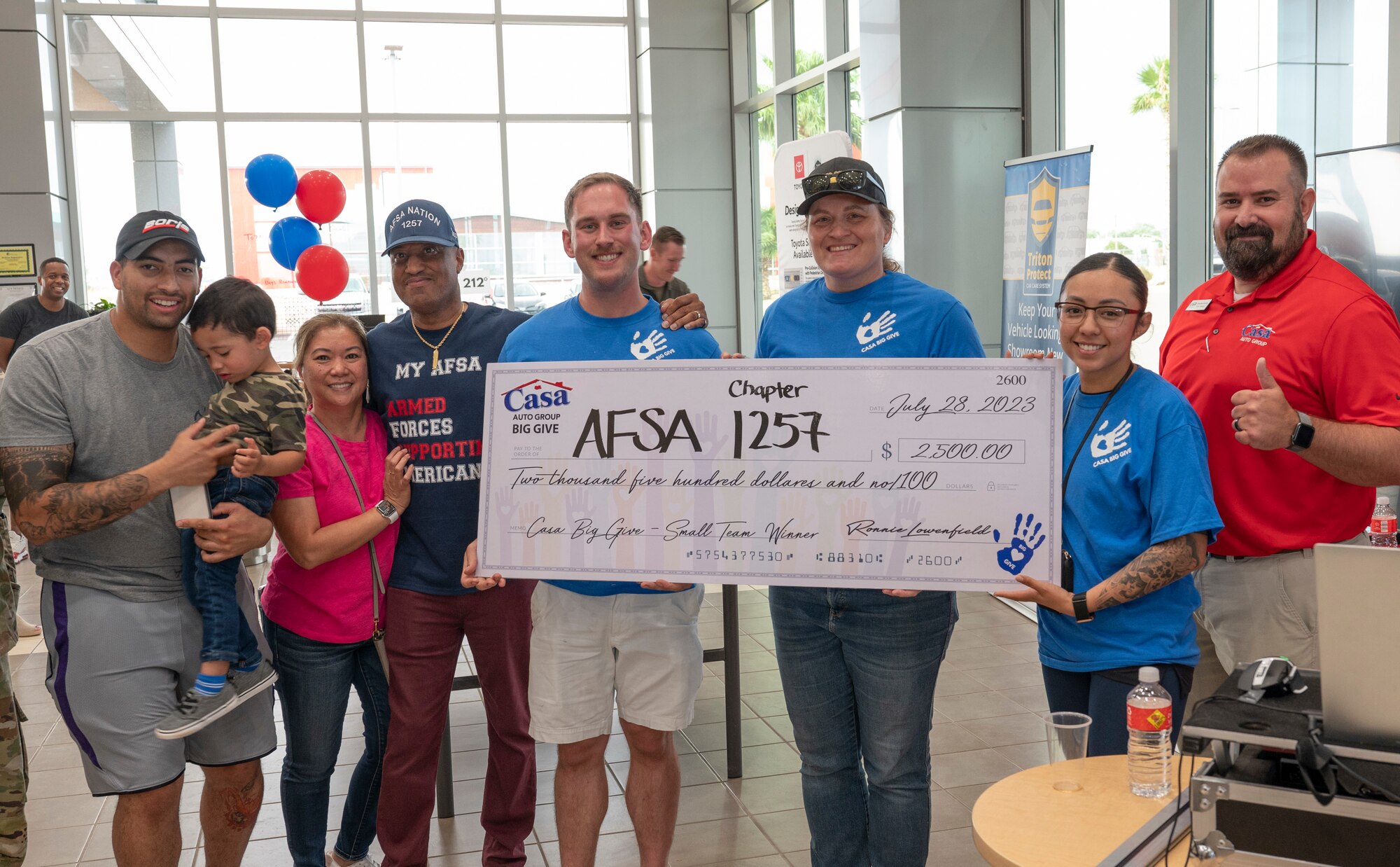 Members of Holloman’s Air Force Sergeants Association accept a check for winning the small team category at the 2023 Casa’s Big Give at the Casa Auto Group, Alamogordo, New Mexico, July 28, 2023. The 13th annual Big Give event was composed of active duty Airmen, civilians and retirees working together to complete projects that benefit the local community. (U.S. Air Force photo by Airman 1st Class Michelle Ferrari)