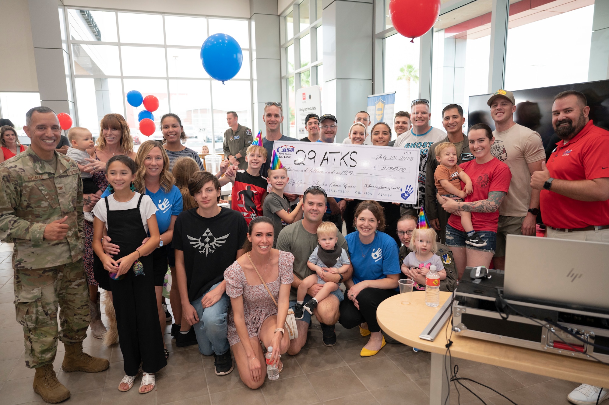Members of the 29th Attack Squadron accept a check for winning the people’s choice category as part of the 2023 Casa’s Big Give at the Casa Auto Group, Alamogordo, New Mexico, July 28, 2023. The 13th annual Big Give event was composed of active duty Airmen, civilians and retirees working together to complete projects that benefit the local community. (U.S. Air Force photo by Airman 1st Class Michelle Ferrari)