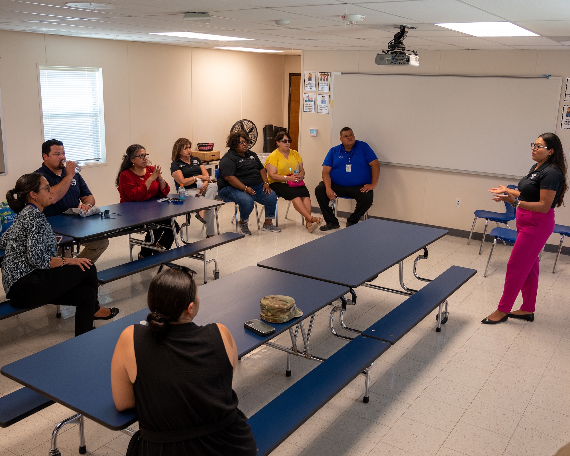 Education Leaders from the San Felipe Del Rio Consolidated Independent School District (SFDR-CISD) listen as Janette Gomez, 47th Force Support Squadron school liaison program manager, speaks about upcoming plans for the Robert Bobby Barrera Elementary School (RBB) at Laughlin Air Force Base, Texas, July 18, 2023. RBB Elementary School provides education for the children of military and civilian families at Laughlin AFB. (U.S. Air Force photo by Senior Airman Nicholas Larsen)