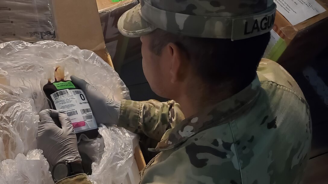A U.S. Soldier supporting Exercise Talisman Sabre 2023 unpacks a box of blood and plasma units after it was transported from Darwin to Townsville, Australia, July 23, 2023. Talisman Sabre is the largest bilateral military exercise between Australia and the United States advancing a free and open Indo-Pacific by strengthening relationships and interoperability among key allies and enhancing our collective capabilities to respond to a wide array of potential security concerns. (Photo courtesy of the U.S. Army/Released)