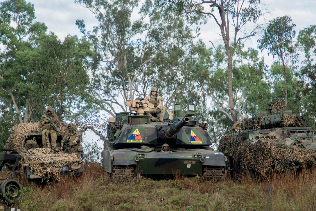 A U.S. Army tank and partner military vehicles sit staged for a group photo to mark the beginning of Talisman Sabre 23 at the Townsville Field Training Area, Australia, July 21, 2023. Following the photo, the New Zealand and Australian army units performed a traditional war ritual.Talisman Sabre is the largest bilateral military exercise between Australia and the United States advancing a free and open Indo-Pacific by strengthening relationships and interoperability among key Allies and enhancing our collective capabilities to respond to a wide array of potential security concerns. (U.S. Army photo by Sgt. Jason Greaves)