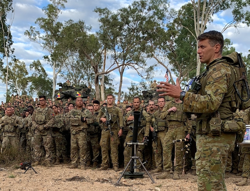 Lt. Col. Benjamin Watson, commanding officer of Battle Group Ram, addresses soldiers from the United States, Australia, New Zealand, France, and Fiji at the beginning of exercise Talisman Sabre 23 in Townsville Field Training Area, Australia, July 21, 2023. The New Zealand and Australian army units performed a traditional war ritual following a group photo with partner nations assigned to Battle Group Ram for the exercise. Talisman Sabre is the largest bilateral military exercise between Australia and the United States advancing a free and open Indo-Pacific by strengthening relationships and interoperability among key Allies and enhancing our collective capabilities to respond to a wide array of potential security concerns. (U.S. Army photo by Maj. Jessica Rovero)