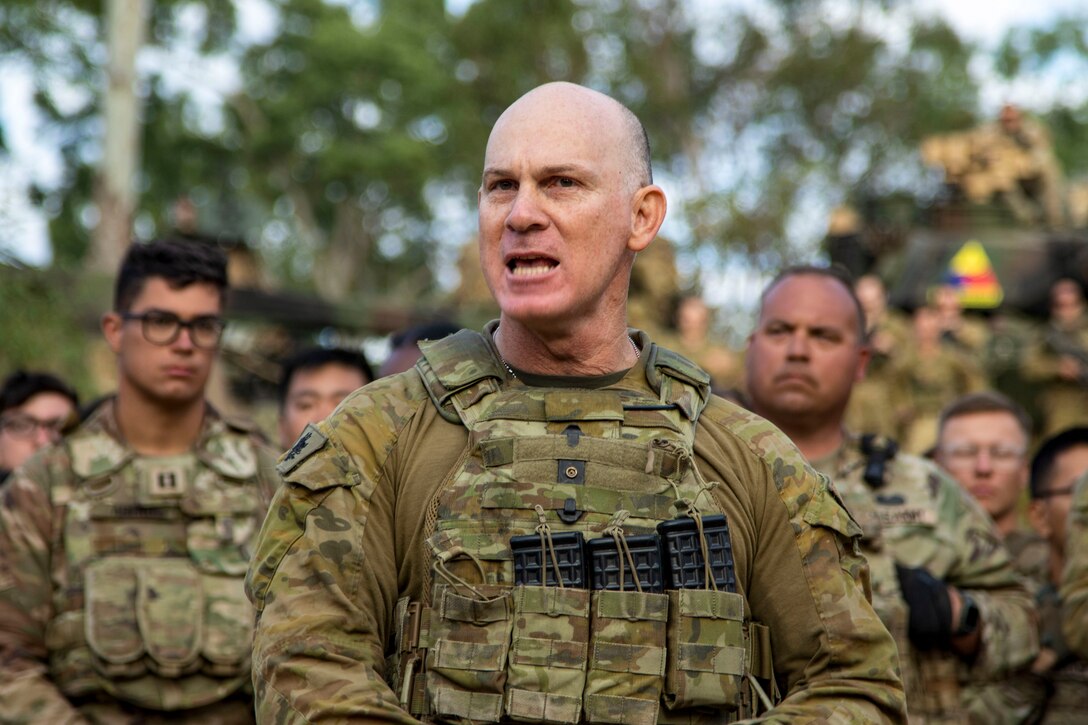 WO1 Corey Dickson, the regimental sergeant major for Battle Group Ram, addresses soldiers from the United States, Australia, New Zealand, France, and Fiji to mark the beginning of Talisman Sabre 23 in Townsville Field Training Area, Australia, July 21, 2023. The New Zealand and Australian army units performed a traditional war ritual following a group photo of partner nations assigned to Battle Group Ram for the exercise. Talisman Sabre is the largest bilateral military exercise between Australia and the United States advancing a free and open Indo-Pacific by strengthening relationships and interoperability among key Allies and enhancing our collective capabilities to respond to a wide array of potential security concerns. (U.S. Army photo by Sgt. Jason Greaves)