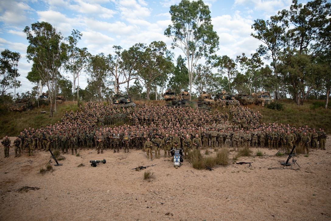 Service members from the United States, Australia, New Zealand, France, and Fiji participating in exercise Talisman Sabre 23 as a part of Battle Group Ram, gather for a group photo to commemorate the start of the exercise July 21, 2023 at the Townsville Field Training Area, Australia. Following the photo, the New Zealand and Australian armies performed a traditional war ritual. Talisman Sabre is the largest bilateral military exercise between Australia and the United States advancing a free and open Indo-Pacific by strengthening relationships and interoperability among key Allies and enhancing our collective capabilities to respond to a wide array of potential security concerns. (U.S. Army photo by Spc. Charlie Duke)