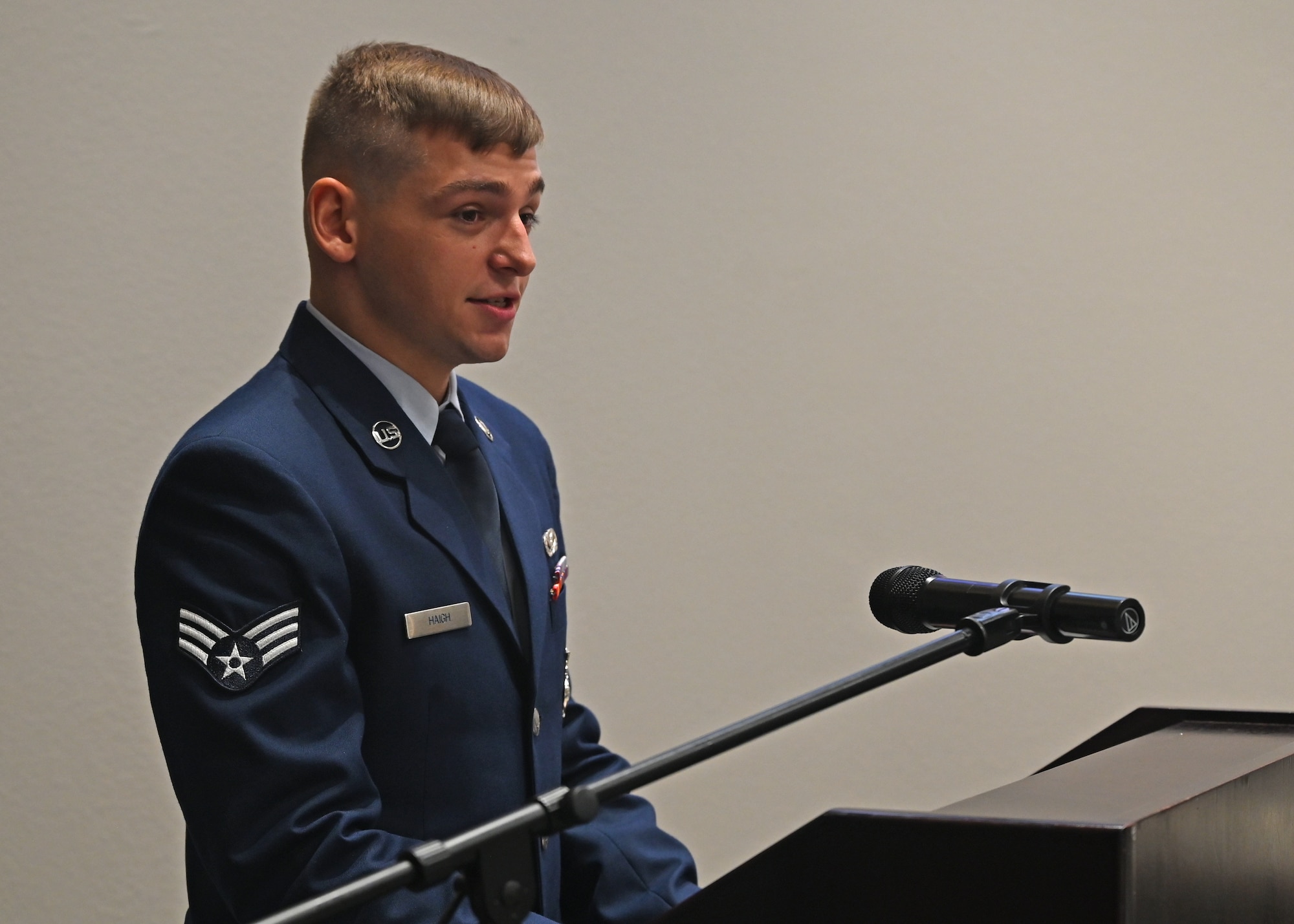 U.S. Air Force Senior Airman Mark Haigh Jr., Class 23-E Airman Leadership School graduate, delivers the class speech at the Class 23-E ALS graduation in the Powell Event Center, Goodfellow Air Force Base, Texas, July 20, 2023. Haigh recounted his time with his class and shared stories of their comradery. (U.S. Air Force photo by Senior Airman Ethan Sherwood)