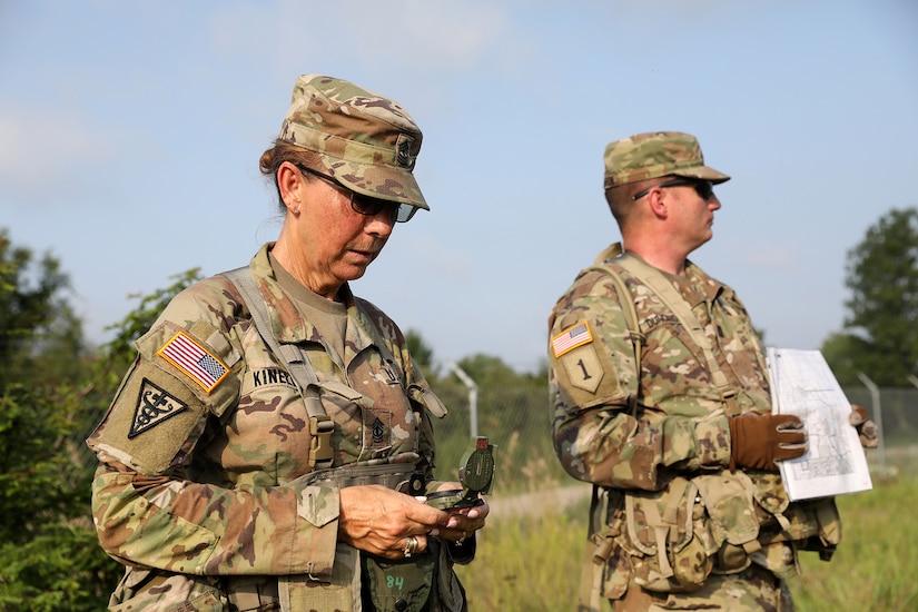 First Sgt. Michelle Kinell, left, 3-338th Transportation Support Battalion, Blacklick, Ohio, works with Capt. Robert Duncanson, S-3, 3-338th TSBN, to locate a point on a land navigation range during Pershing Strike at Camp Atterbury, Indiana.