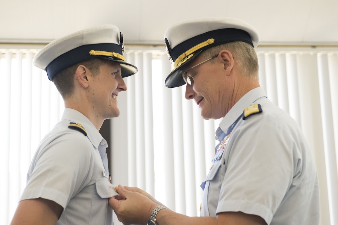 Vice Adm. Peter W. Gautier, Deputy Commandant for Operations, pins Lt. Cmdr. Kenneth Miltenberger as 2003 Cyber Protection Team's commanding officer during an establishment ceremony at Coast Guard Island, Alameda, California, Aug. 1, 2023. The new unit's mission is to provide assessments, hunt cyber threats, and supply incident response capabilities to the Marine Transportation System. (U.S. Coast Guard Photo by Petty Officer 2nd Class Edward Wargo)