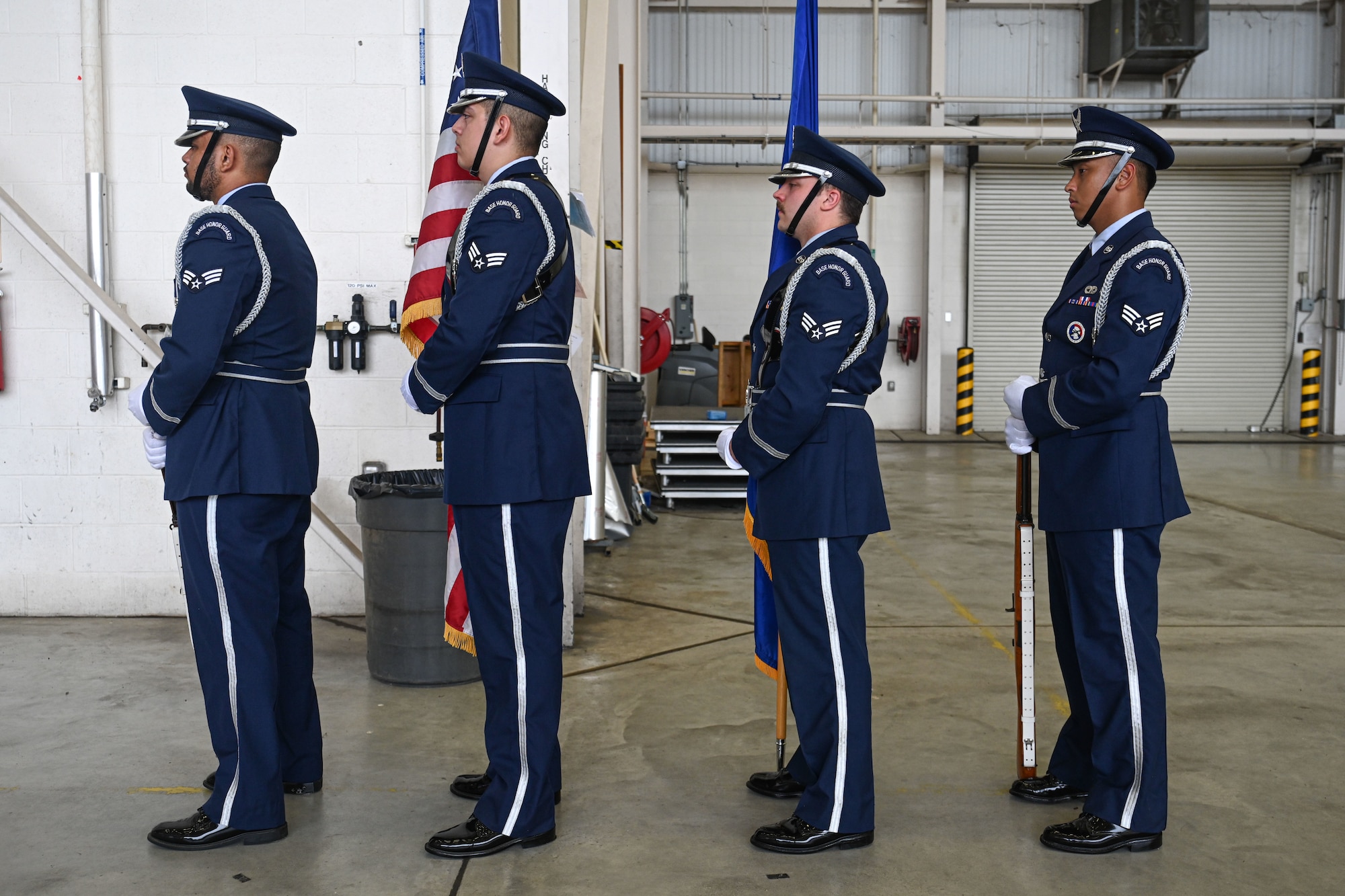 Base honor guard members prepare to present colors.