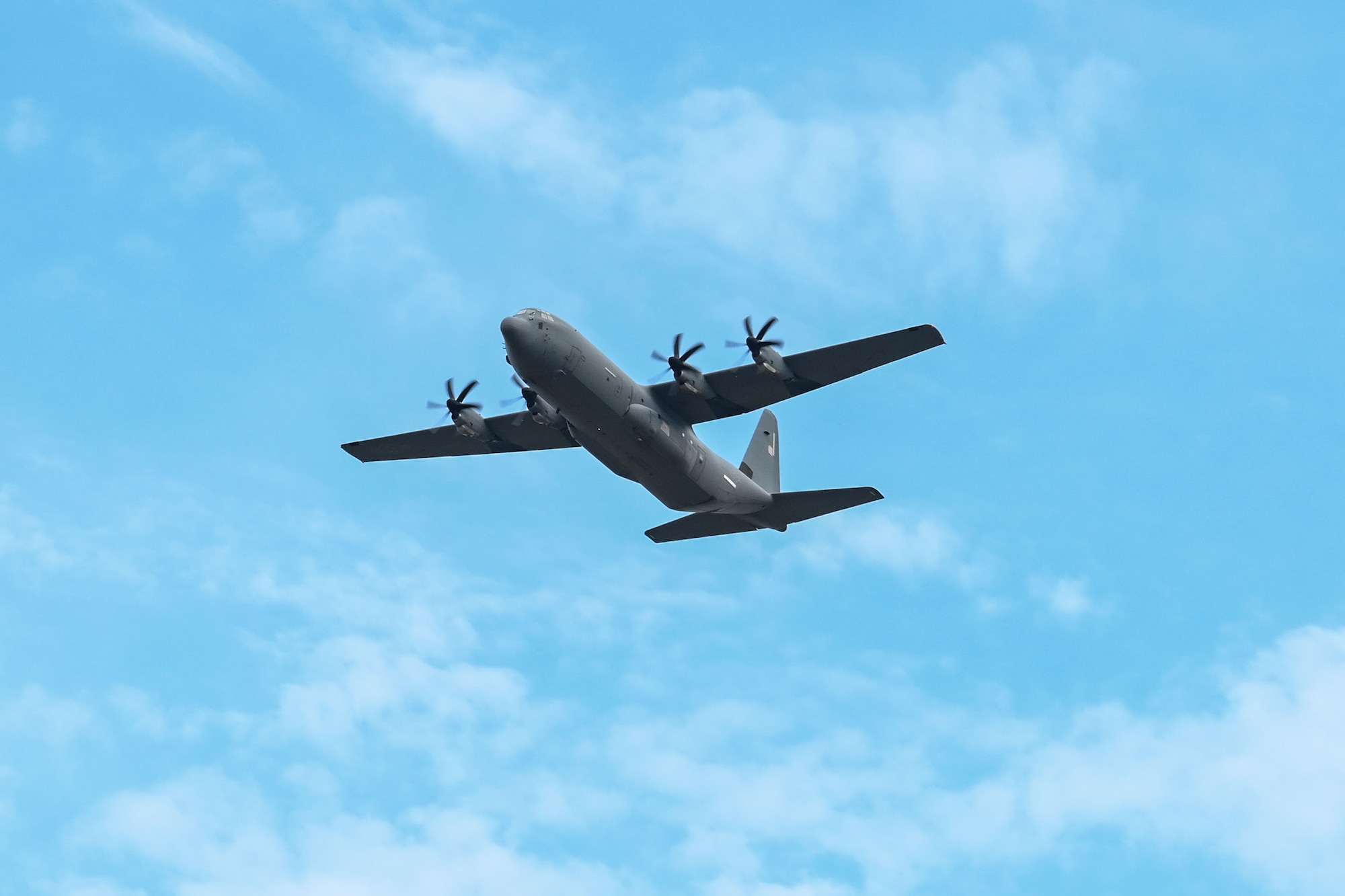 A C-130 flies overhead.