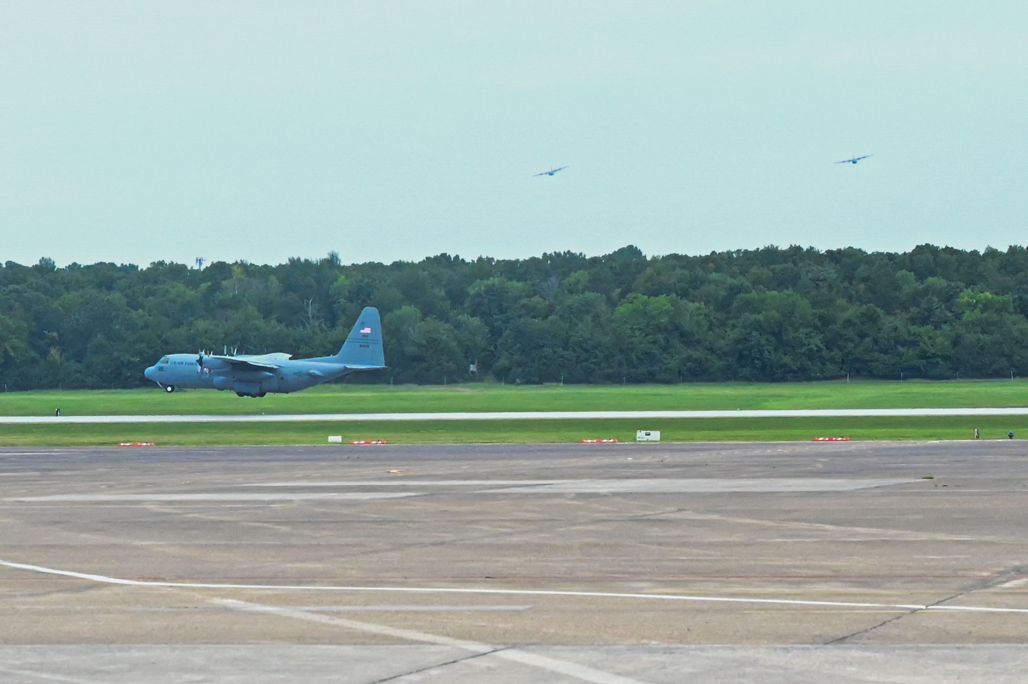 A C-130 takes off from the runway.