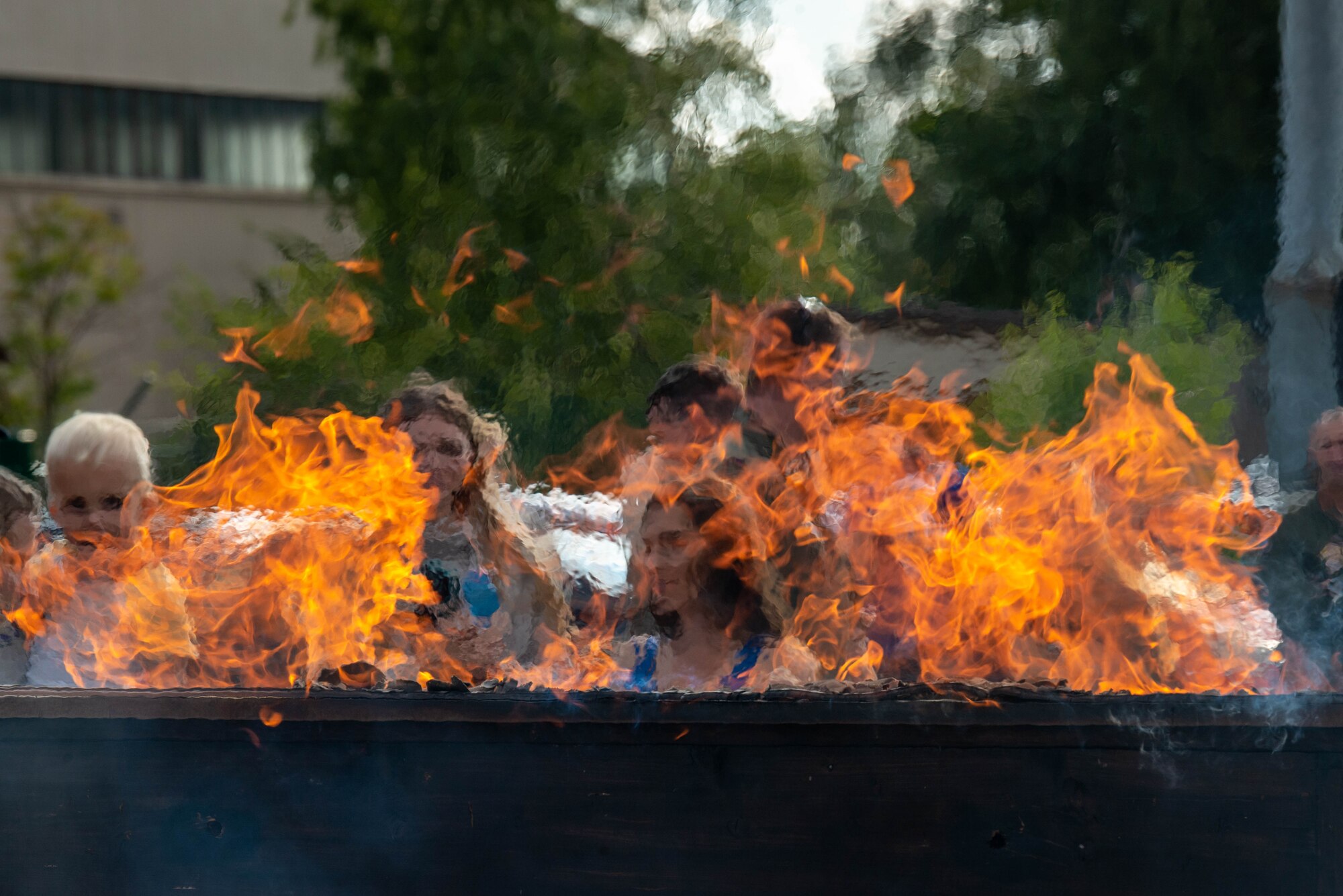 Airmen assigned to the 76th Airlift Squadron participate in a piano burning ceremony
