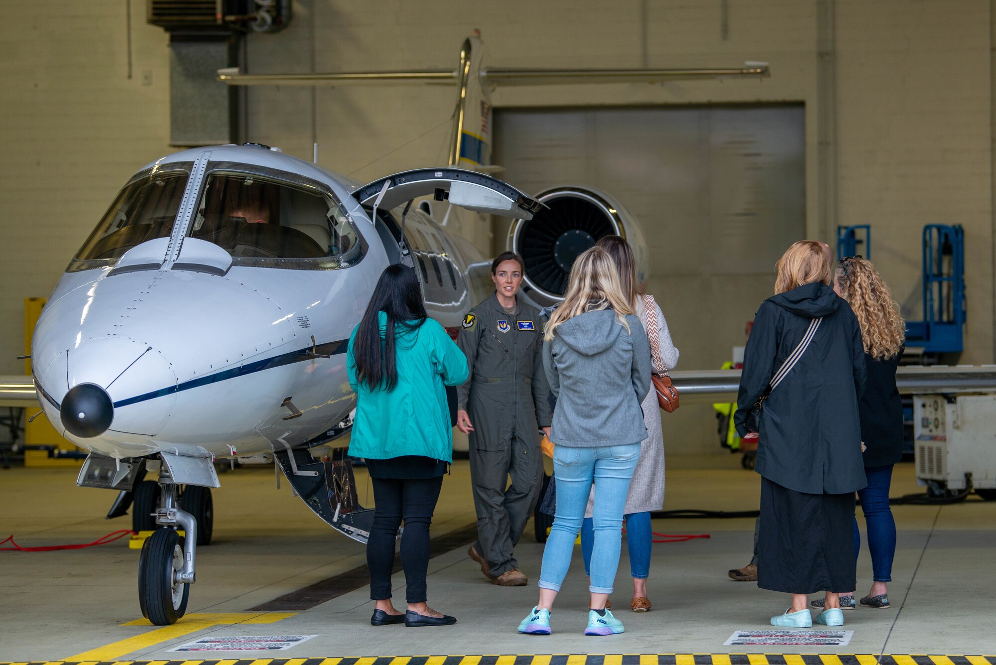 Airmen stand around a C-21A aircraft