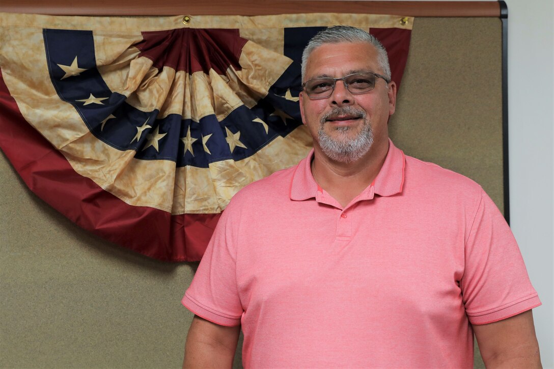 The National Guard Bureau awards the Mission Execution Grants & Cooperative Agreements Award to Patrick Cabinaw, a grants officer representative for the Pennsylvania National Guard’s United States Property and Fiscal Office July 18. The annual award is one of 20 in various categories awarded annually by the NGB’s USPFO Excellence in Contracting and Agreements Award Program. (U.S. Army National Guard photo by Sgt. 1st Class Zane Craig)