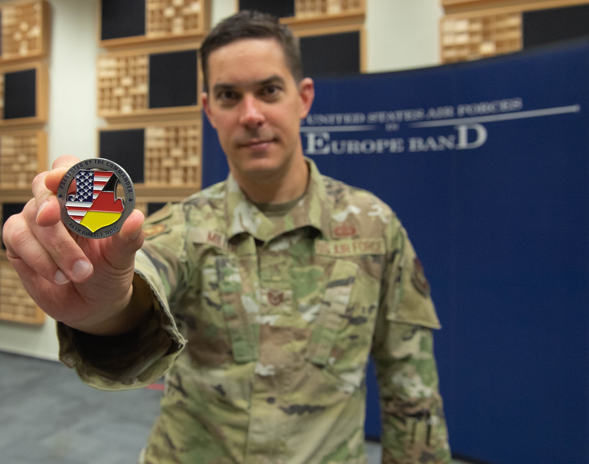 An Airman displays a coin