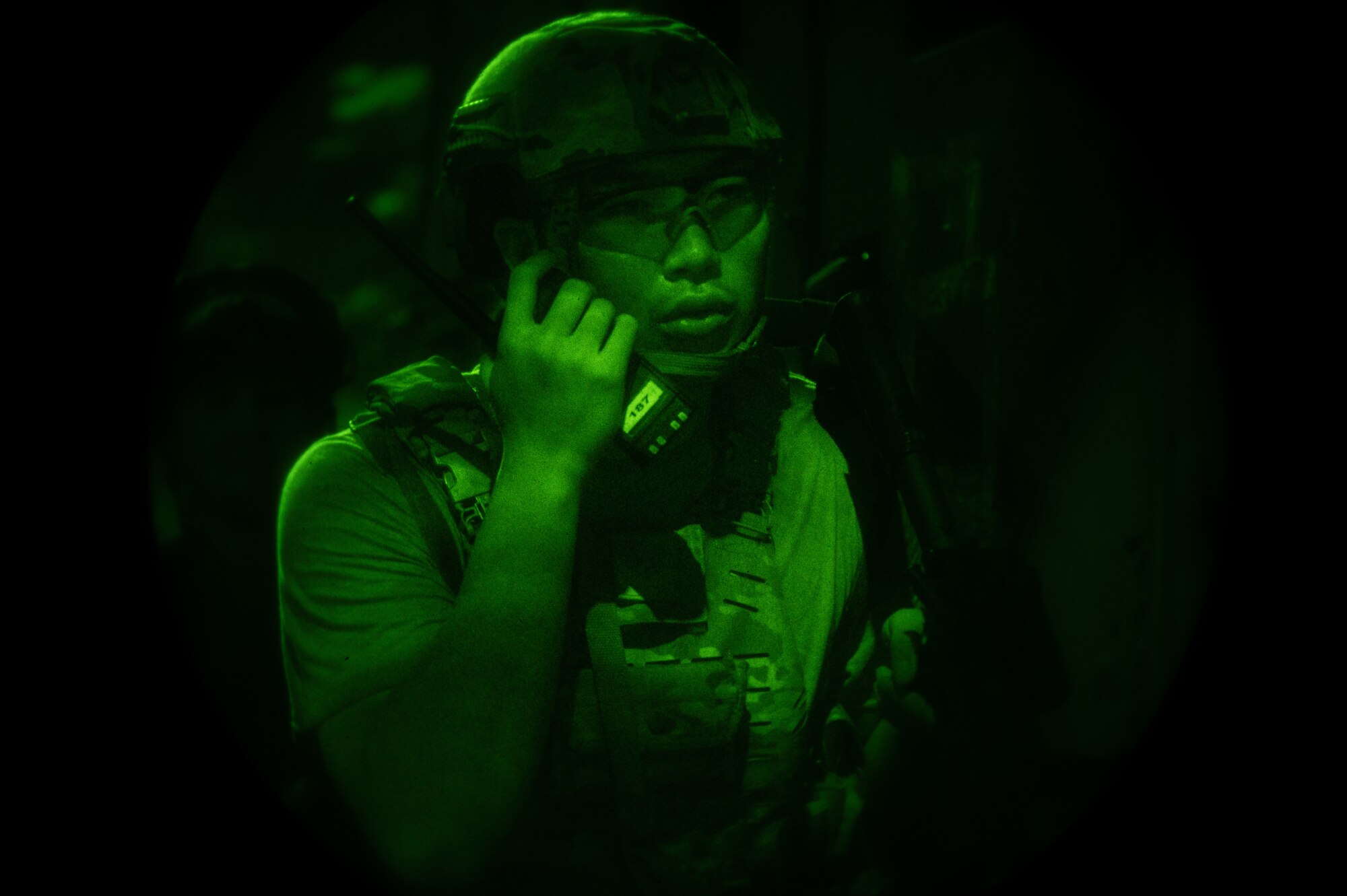 A U.S. Air Force Defender from the 51st Security Forces Squadron, communicates with his team during a simulated ground attack at Osan Air Base, Republic of Korea, Aug. 1, 2023. Simulated ground attacks allow Defenders to develop and refine their tactics, techniques, and procedures in response to different enemy scenarios. (U.S. Air Force photo by Staff Sgt. Thomas Sjoberg)