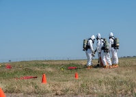 U.S. Airmen, assigned to the 5th Civil Engineer Squadron explosive ordnance disposal (EOD) flight, mark off an area during a readiness exercise at Minot Air Force Base, North Dakota, July 27, 2023. The Airmen surveyed areas and neutralized inert ordnance as part of Operation Frozen Peanut. (U.S. Air Force photo by Airman 1st Class Kyle Wilson)