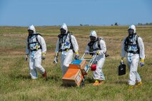 U.S. Airmen, assigned to the 5th Civil Engineer Squadron explosive ordnance disposal (EOD) flight, perform area sweeps during a readiness exercise at Minot Air Force Base, North Dakota, July 27, 2023. The Airmen participated in Operation Frozen Peanut to test and enhance readiness. (U.S. Air Force photo by Airman 1st Class Kyle Wilson)