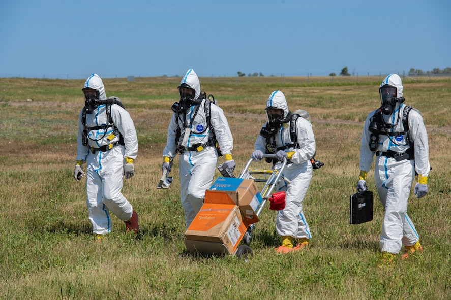 U.S. Airmen, assigned to the 5th Civil Engineer Squadron explosive ordnance disposal (EOD) flight, perform area sweeps during a readiness exercise at Minot Air Force Base, North Dakota, July 27, 2023. The Airmen participated in Operation Frozen Peanut to test and enhance readiness. (U.S. Air Force photo by Airman 1st Class Kyle Wilson)