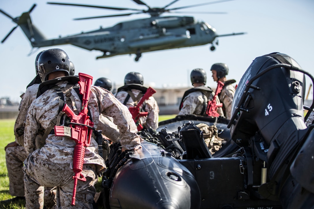 U.S. Marines with Basic Reconnaissance Course wait with a combat rubber raiding craft to be picked up by a CH-53E Super Stallion helicopter to conduct a helocasting training at Naval Amphibious Base Coronado, California, Oct. 29, 2019. BRC is one of the many courses taught by the staff at Reconnaissance Training Company, Advanced Infantry Training Battalion, School of Infantry - West. The course provides students with the basic knowledge of reconnaissance doctrine, concepts, and techniques with emphasis on amphibious entry and extraction, beach reconnaissance and reconnaissance patrolling skills. (Marine Corps photo by Lance Cpl. Andrew Cortez)